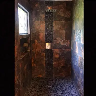 a bathroom with a stone shower with a window at Private Home in Montezuma with Ocean View in Montezuma