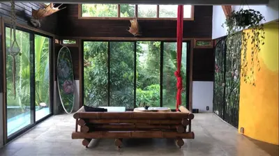 a living room with a couch and large windows at Private Home in Montezuma with Ocean View in Montezuma