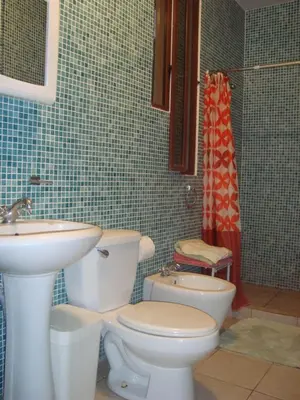a bathroom with a toilet and a sink at Casa La Guaria in Sámara
