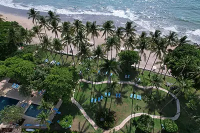 an aerial view of a resort with palm trees and the ocean at Hotel Tamarindo Diria Beach Resort in Tamarindo