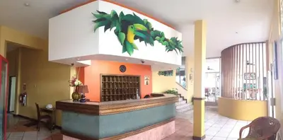 a restaurant with a food counter in a building at Park Hotel in Puerto Limón