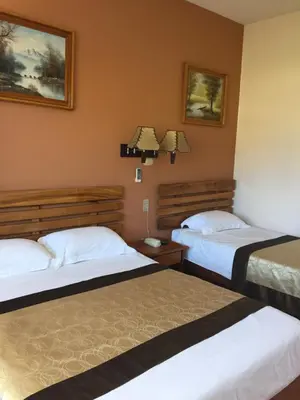 a hotel room with two beds in a room at Park Hotel in Puerto Limón