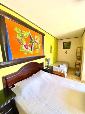 a hotel room with a bed and a bedroom with at Hotel Vista Linda Montaña in Alajuela City