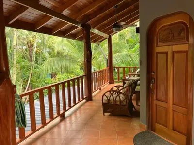 a porch of a house with a wooden door at Villa Tortuga in Nosara