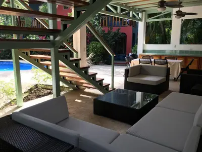a living room with a couch and a table at Villa Tortuga in Nosara