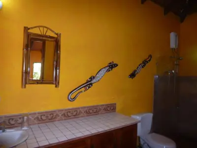 a bathroom with three fish decals on the wall at La Palapa Ecolodge in Portalón