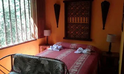 a bedroom with a bed with towels on it at La Palapa Ecolodge in Portalón
