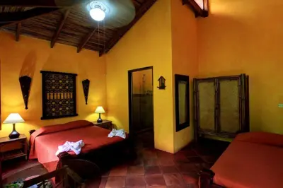 a bedroom with a red bed in a room at La Palapa Ecolodge in Portalón