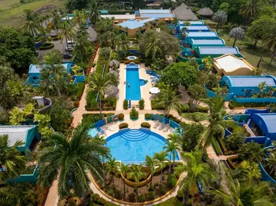 an aerial view of a resort with a pool and palm trees at Alma del Pacifico Hotel & Spa in Esterillos Este
