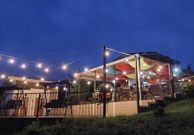 a restaurant lit up at night with lights at Eco Granja Don Lolo in Quesada