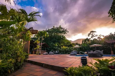 a garden with a patio and a swimming pool at Casa Luna Hotel & Spa in Fortuna