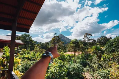 a person pointing at a mountain in the distance at Casa Luna Hotel & Spa in Fortuna