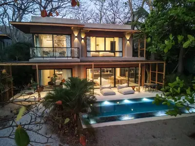 a house with a swimming pool in front of it at Hotel Nantipa - A Tico Beach Experience in Santa Teresa Beach