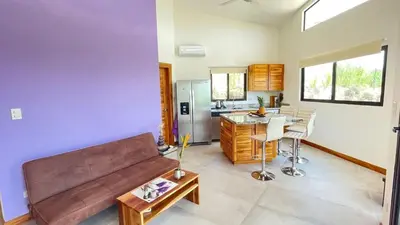a living room with a couch and a table at Villas Roma Del Mar in Playa Naranjo