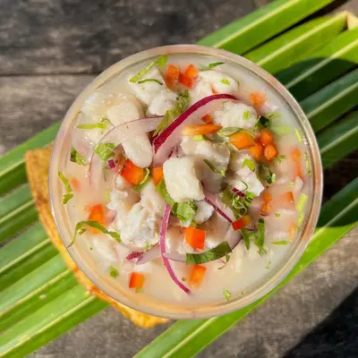 a bowl of soup with carrots onions and celery at Villas Roma Del Mar in Playa Naranjo