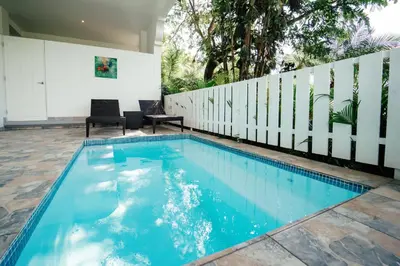 a swimming pool in the middle of a house at Shana by the Beach Manuel Antonio in Manuel Antonio
