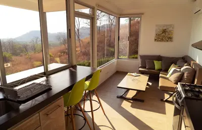 a kitchen and living room with large windows and a couch at Horizon Lodge Potrero in Potrero