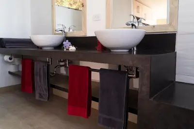 a bathroom with two sinks and towels on a counter at Horizon Lodge Potrero in Potrero