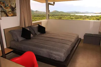 a bedroom with a bed and a large window at Horizon Lodge Potrero in Potrero