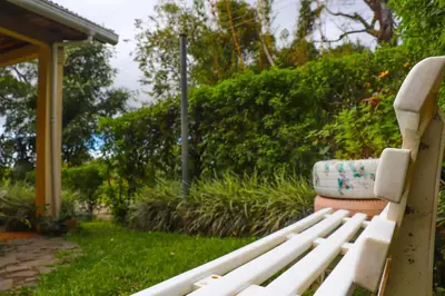 a white bench sitting in a yard with at Casa Copalchi in Monteverde Costa Rica