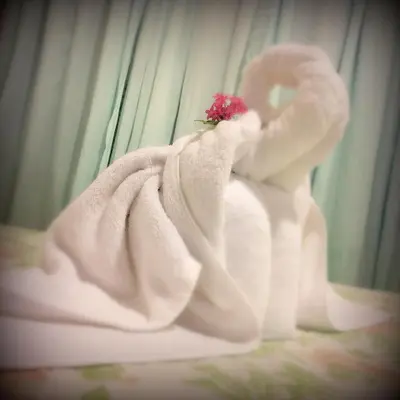 a white towel with a flower on top of it at Casa Copalchi in Monteverde Costa Rica