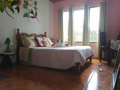 a bedroom with a bed with a stuffed animal on it at Casa Copalchi in Monteverde Costa Rica