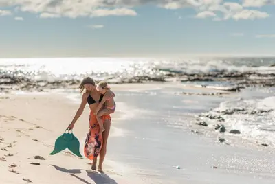 a woman is walking on the beach at Cala Luna Boutique Hotel & Villas in Tamarindo