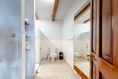 a bathroom with a toilet and a sink at Villas Alturas in Dominical