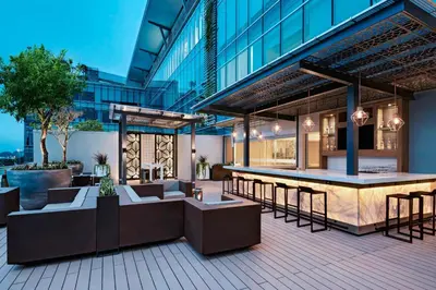 an outdoor patio with a bar in a building at AC Hotel by Marriott San Jose Escazu in San José
