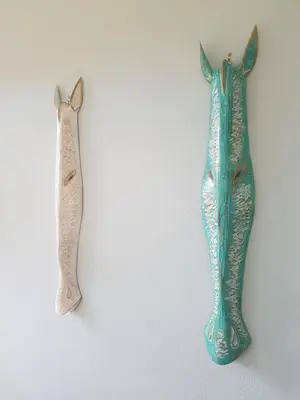 two fish decorations hanging on a wall at Casa Malia Guapinol #8 in Tamarindo