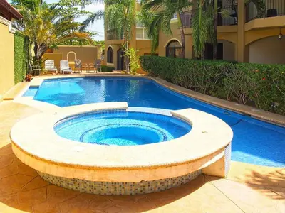 a large swimming pool in a yard next to a building at Casa Malia Guapinol #8 in Tamarindo