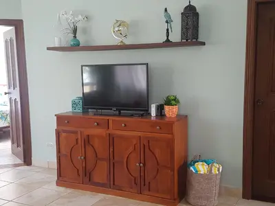 a television on a wooden cabinet in a living room at Casa Malia Guapinol #8 in Tamarindo