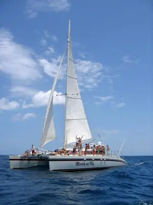 a group of people on a sail boat in the ocean at Hotel Arco Iris in Tamarindo