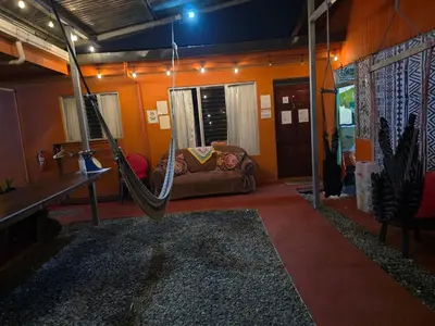 a room with a hammock and a couch at Alojamientos N&S in Fortuna