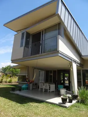 a house with a balcony and a patio at Casa Nadette in Guácima