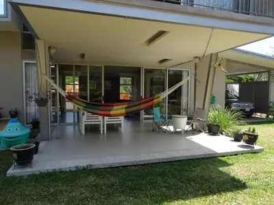 a hammock on the porch of a house at Casa Nadette in Guácima