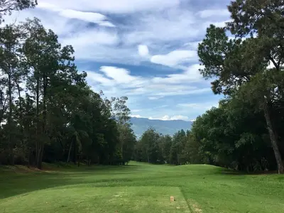 a golf course with trees and a green field at Casa Nadette in Guácima