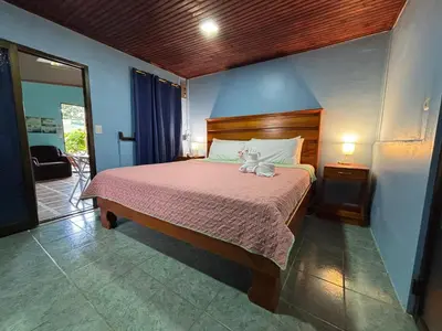 a bedroom with a bed with a stuffed animal on it at Pura Vida Aparment - Downtown La Fortuna in Fortuna