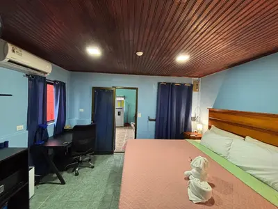 a bedroom with a bed with a stuffed animal on it at Pura Vida Aparment - Downtown La Fortuna in Fortuna