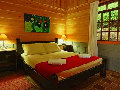 a bedroom with a bed in a wooden room at Rancho Amalia in Naranjo
