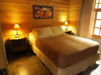 a bedroom with a bed and two lamps on tables at Rancho Amalia in Naranjo