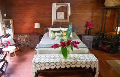a bedroom with a bed with flowers on it at The House of Hummingbird, Costa Rica in Atenas