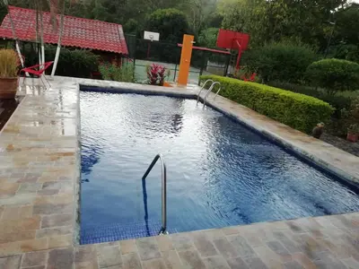 a swimming pool in a yard with a pool at The House of Hummingbird, Costa Rica in Atenas