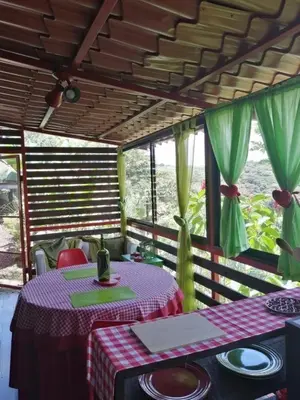 a dining room with a table with plates on it at The House of Hummingbird, Costa Rica in Atenas