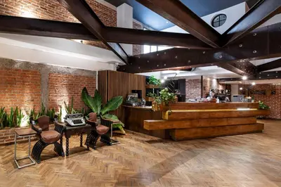 a restaurant with a counter and a table and chairs at Hotel Presidente in San José