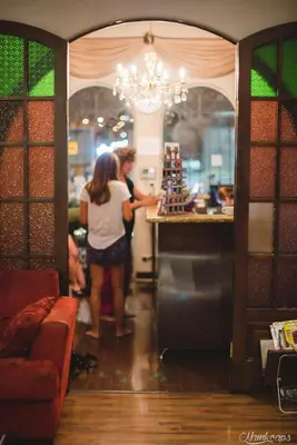 two women standing at a counter in a restaurant at Hotel Casa Colon in San José