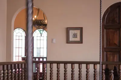 a staircase with two stained glass windows and a door at Hotel Casa Colon in San José