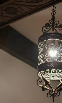a chandelier hanging in front of a mirror at Hotel Casa Colon in San José