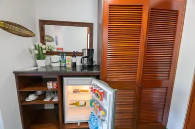 a kitchen with an open refrigerator next to a counter at Club del Mar Oceanfront in Jacó