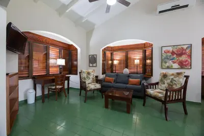 a living room with a couch and a table at Club del Mar Oceanfront in Jacó